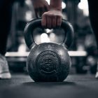 a person holding a kettle in a gym
